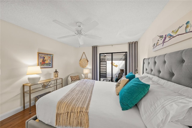 bedroom with ceiling fan, a textured ceiling, and hardwood / wood-style flooring