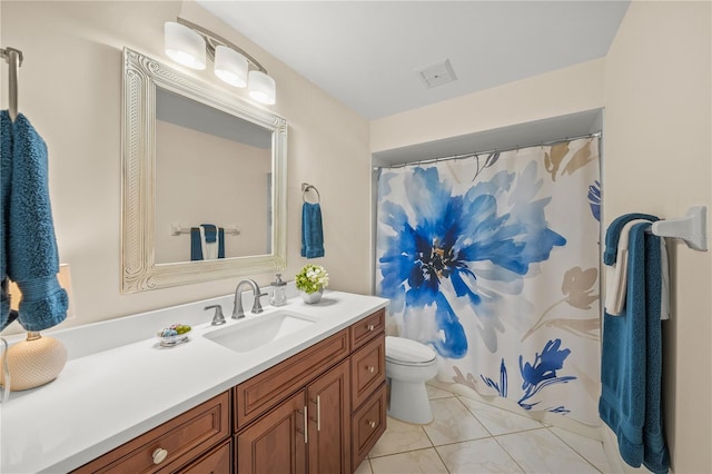 bathroom featuring tile patterned floors, vanity, and toilet