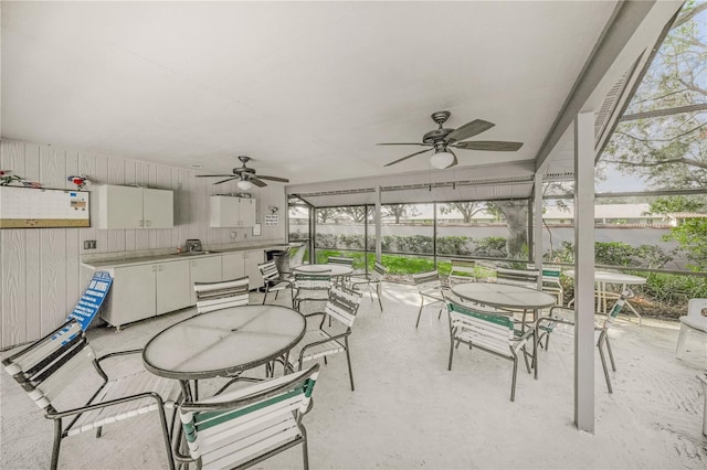 sunroom featuring ceiling fan