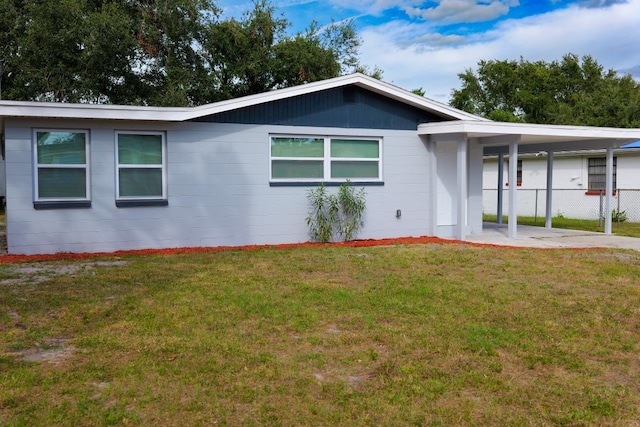 single story home featuring a carport and a front yard