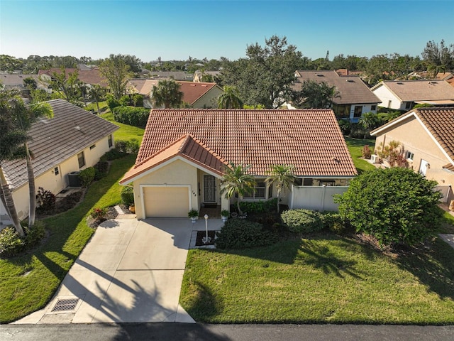 view of front of house with a garage and a front lawn