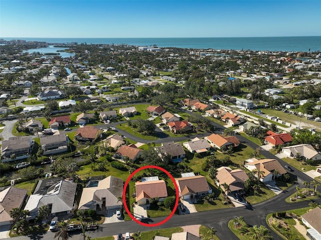 drone / aerial view featuring a water view and a residential view