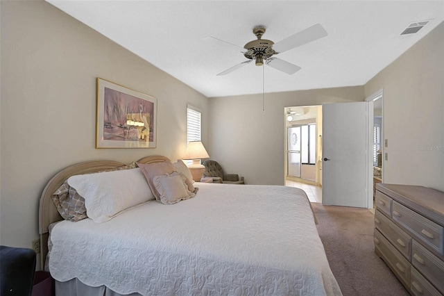 bedroom with ceiling fan, carpet floors, and visible vents