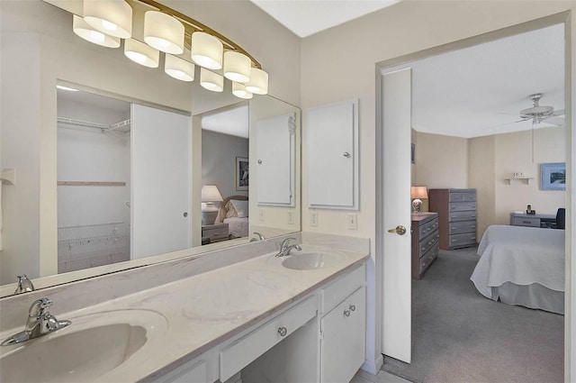 full bathroom with a sink, double vanity, connected bathroom, and a ceiling fan