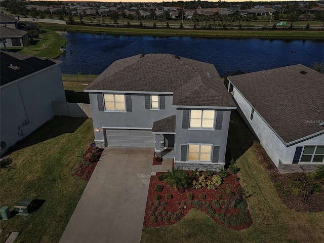 view of front of house featuring a garage and a water view