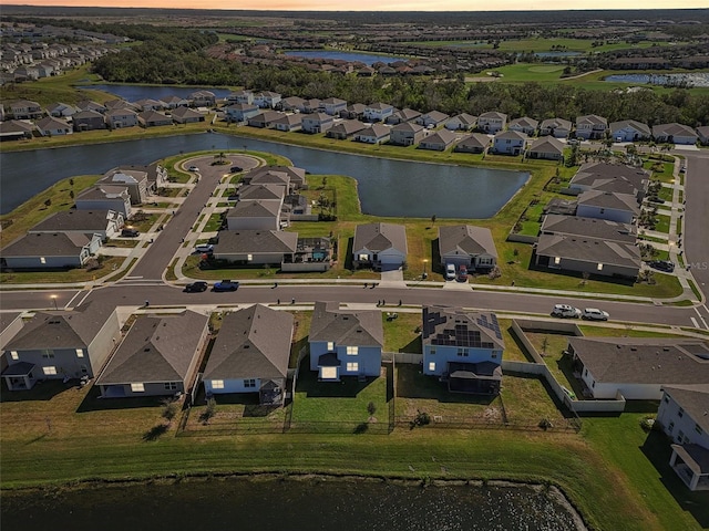 aerial view at dusk with a water view