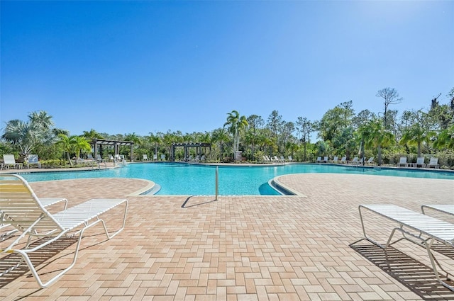 view of pool with a pergola and a patio area