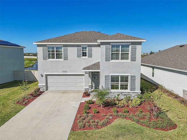 view of front of home with a front yard and a garage