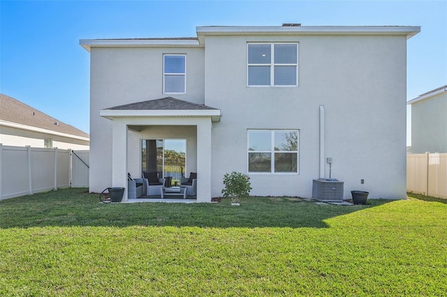 back of house featuring outdoor lounge area, cooling unit, a patio area, and a yard