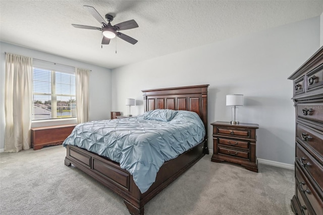 carpeted bedroom featuring a textured ceiling and ceiling fan