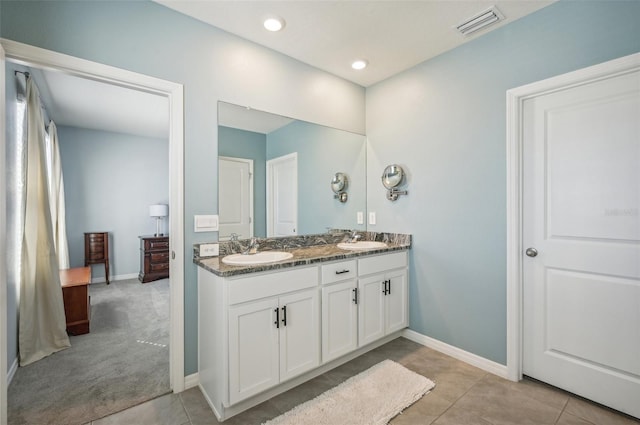 bathroom with tile patterned floors and vanity