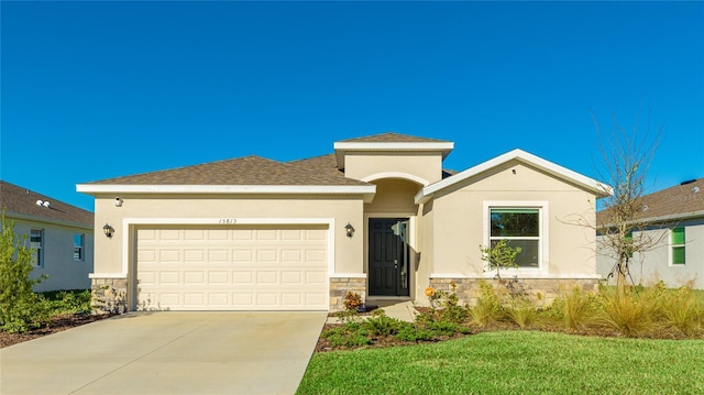 view of front of property with a garage and a front yard