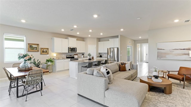 15813 6th Ave E, Bradenton, FL 34212 - living area with recessed lighting, light tile patterned floors, and baseboards