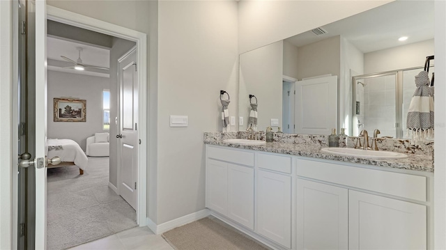 bathroom with vanity, an enclosed shower, and ceiling fan