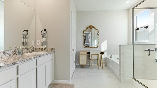 bathroom with tile patterned flooring, vanity, and separate shower and tub