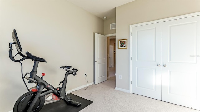 exercise room featuring light colored carpet