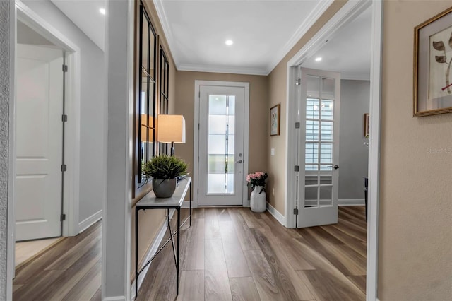 entryway featuring hardwood / wood-style flooring and crown molding