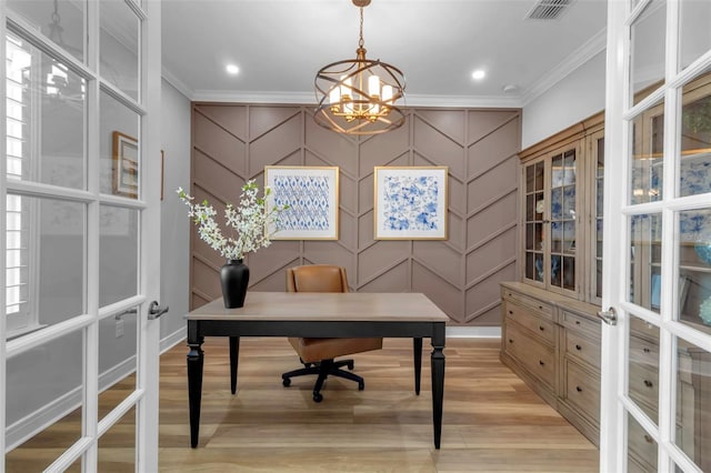 office area with light hardwood / wood-style floors, ornamental molding, and french doors