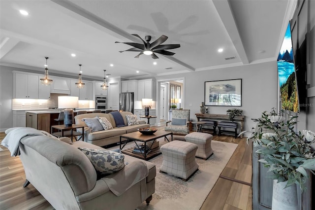 living room with ceiling fan, ornamental molding, and light wood-type flooring