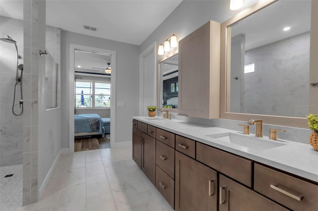 bathroom featuring vanity and tiled shower