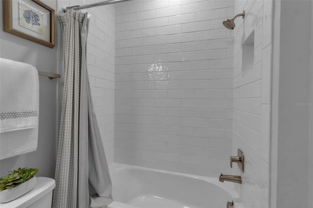 bathroom with shower / bath combo and toilet