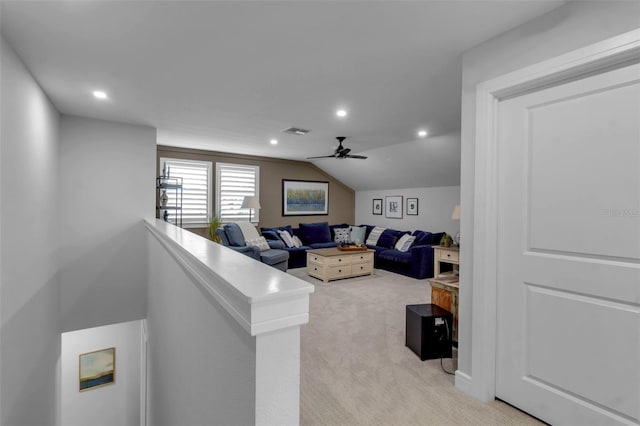 living room featuring ceiling fan, light carpet, and lofted ceiling