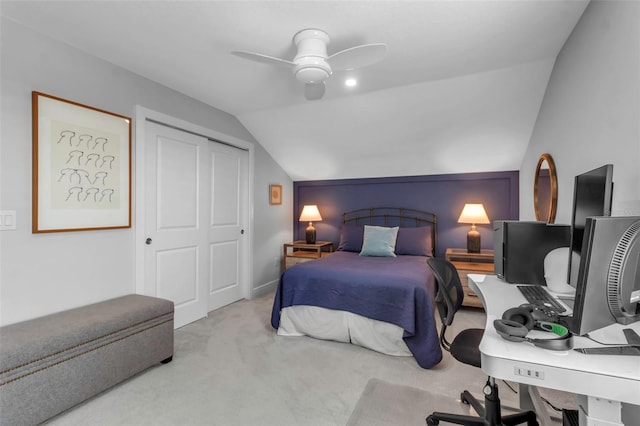 bedroom with light colored carpet, a closet, vaulted ceiling, and ceiling fan