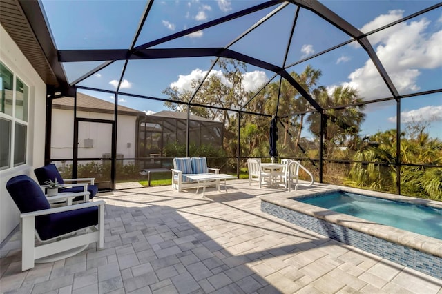 view of swimming pool featuring glass enclosure, a jacuzzi, and a patio