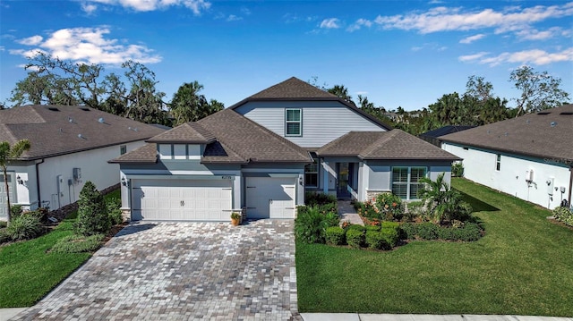 view of front of property featuring a front yard and a garage