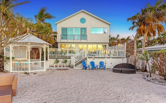 rear view of property with a balcony