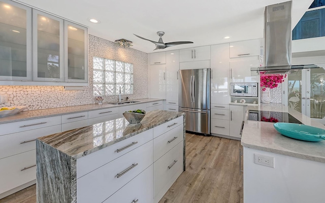 681 Casey Key Rd, Nokomis, FL 34275 - kitchen with stainless steel appliances, island exhaust hood, white cabinets, decorative backsplash, and modern cabinets