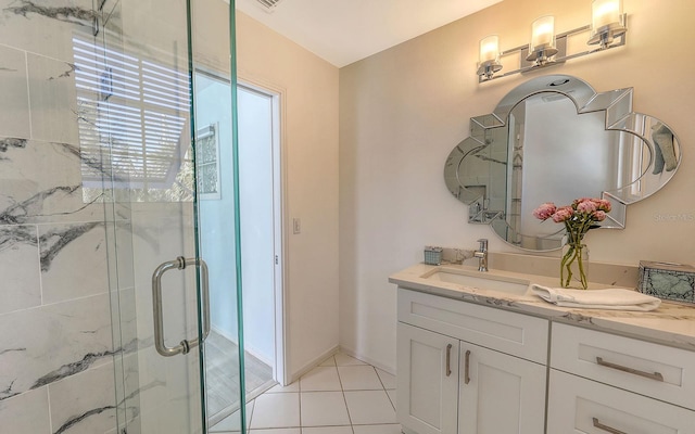 bathroom featuring vanity, tile patterned floors, and an enclosed shower