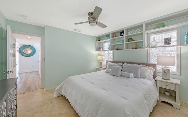 bedroom with light hardwood / wood-style flooring and ceiling fan