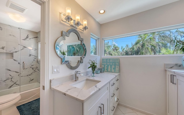 full bathroom with toilet, vanity, tile patterned floors, and tiled shower / bath combo