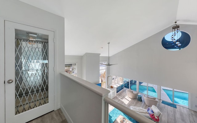 hallway featuring hardwood / wood-style floors and vaulted ceiling