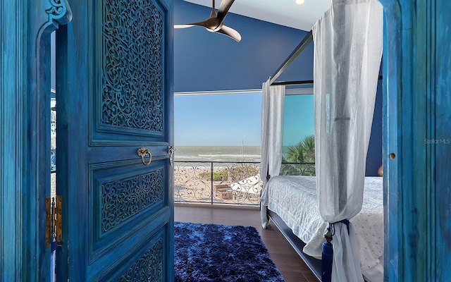 bedroom with ceiling fan, wood-type flooring, and vaulted ceiling