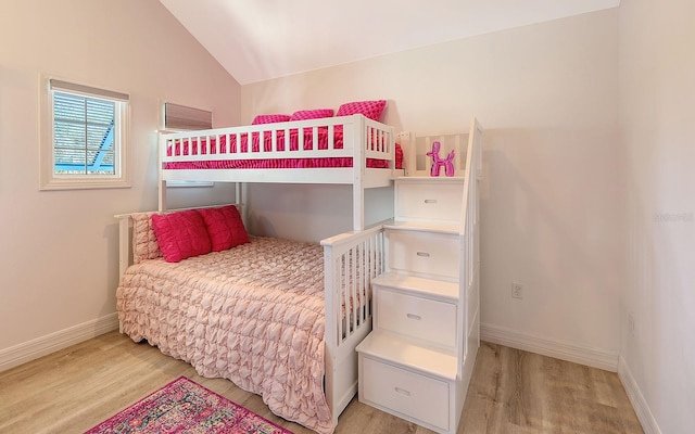 bedroom featuring light hardwood / wood-style flooring and vaulted ceiling