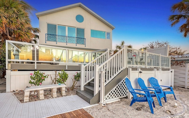 rear view of property featuring a balcony