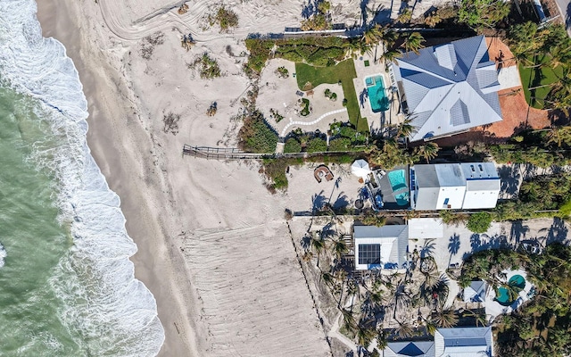 bird's eye view featuring a view of the beach and a water view