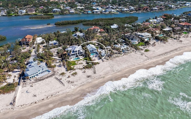 birds eye view of property with a view of the beach and a water view