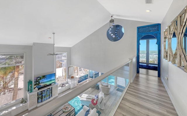 681 Casey Key Rd, Nokomis, FL 34275 - hallway featuring healthy amount of natural light, lofted ceiling, wood finished floors, and french doors