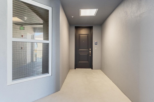 corridor featuring light colored carpet