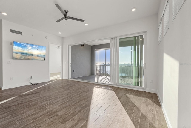 spare room with ceiling fan and wood-type flooring