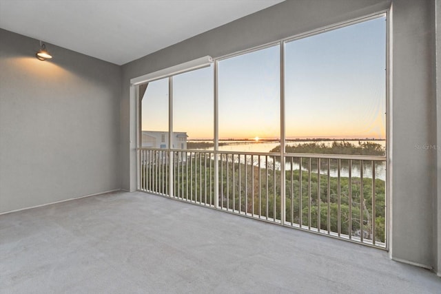 unfurnished sunroom with a water view