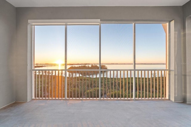 unfurnished sunroom with a water view