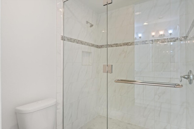 bathroom with an enclosed shower and toilet