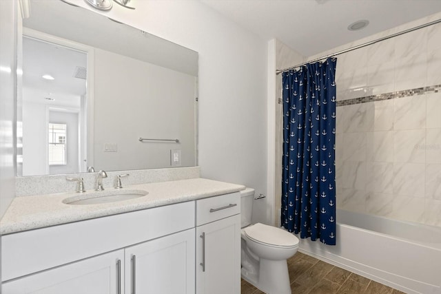 full bathroom featuring shower / bath combo with shower curtain, toilet, wood-type flooring, and vanity