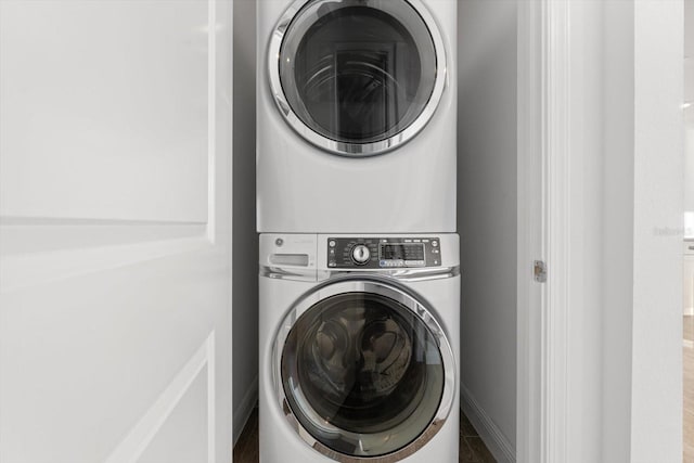 laundry room with stacked washer and dryer