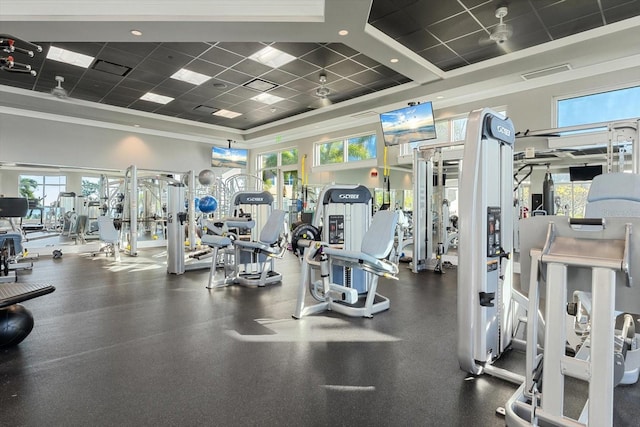 workout area with a paneled ceiling and crown molding