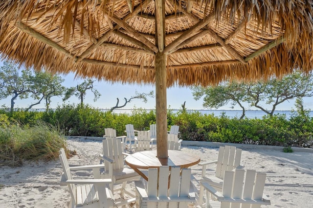 view of patio with a gazebo and a water view